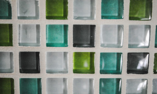 blue, green and clear glass tile with light gray grout